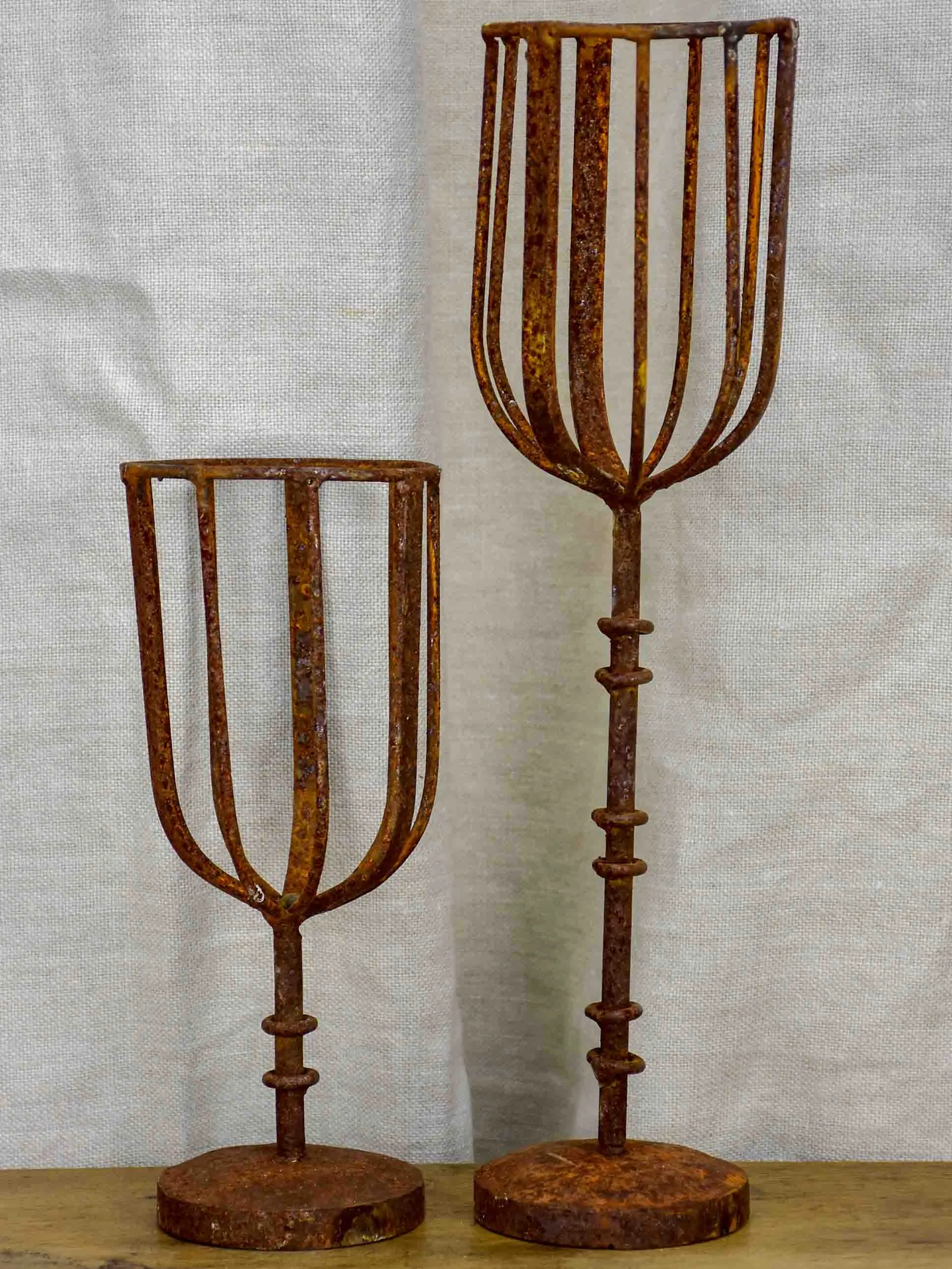 Pair of cup-shaped rustic candlesticks